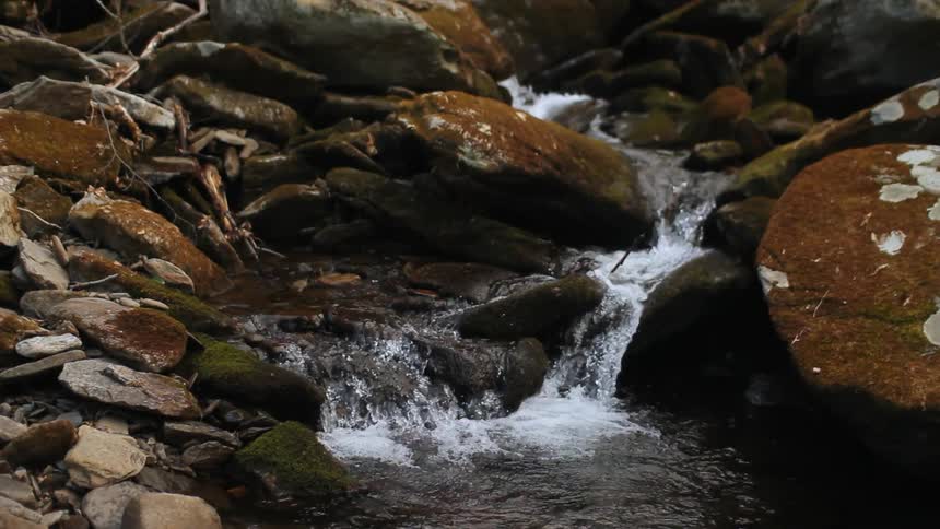 Water flows down a rocky stream