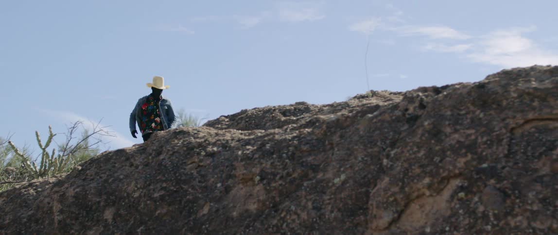 A rancher takes off running through open land