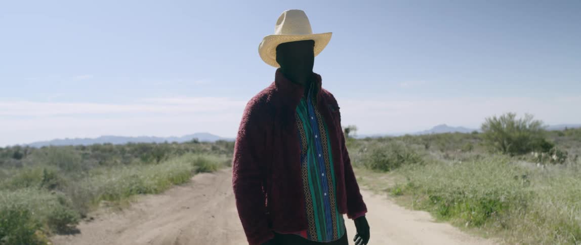 A man in a morph suit standing in a field