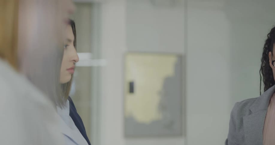 Three woman standing in an office talking