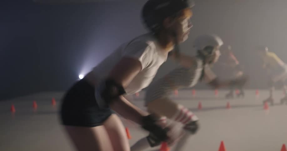 Women compete in roller skate race indoors