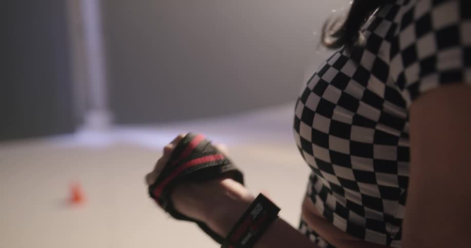 A woman secures her gloves onto her hands