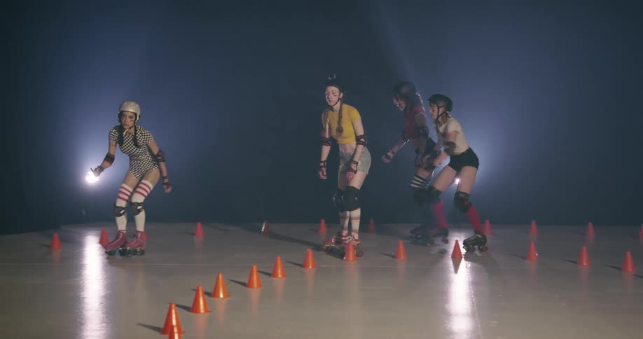 Women with helmets roller skating indoors