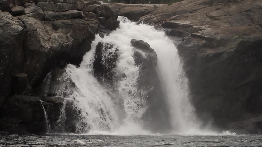 Looking at a waterfall over a rocky cliff