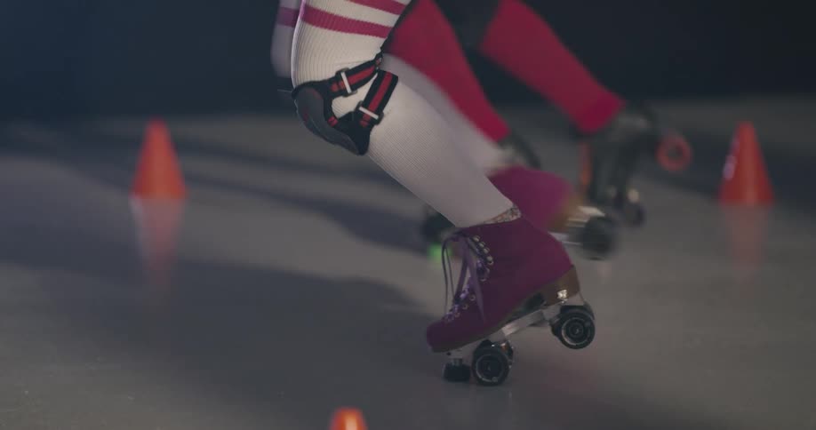 Women move along the ground using roller skates in the roller skating rink
