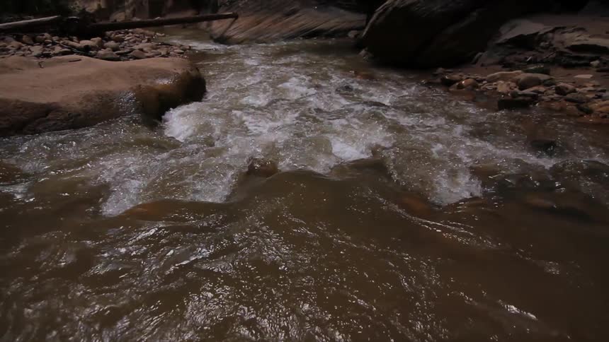 A stream is flowing down a narrow canyon