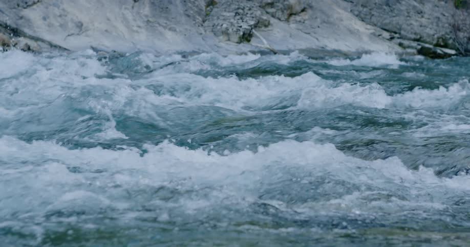 A river flowing with a rocky bank