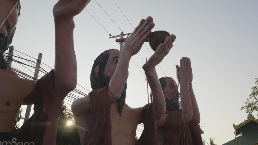 Statues hold objects and one prays
