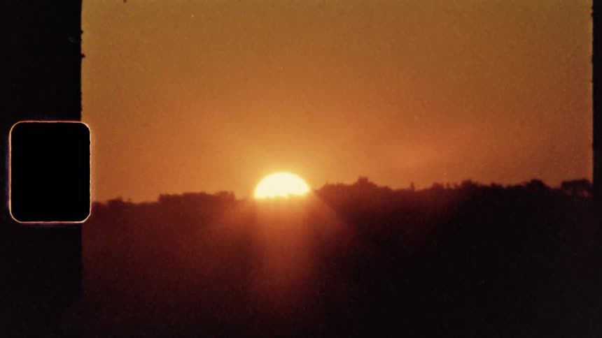 A sunset with the sky in the background on vintage film