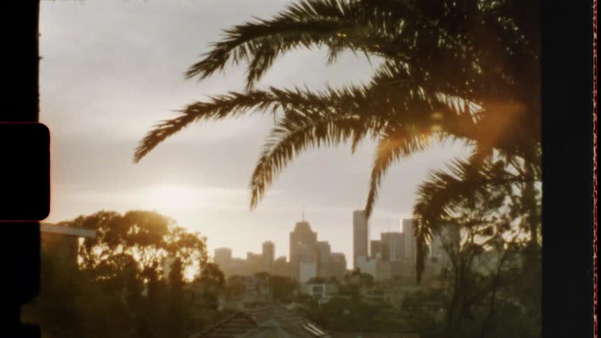 Skyline of the city with tall buildings and skyscrapers at sunset 8mm film