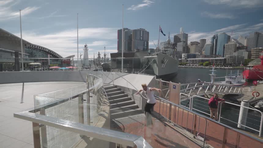 An inline skater does a trick in the city