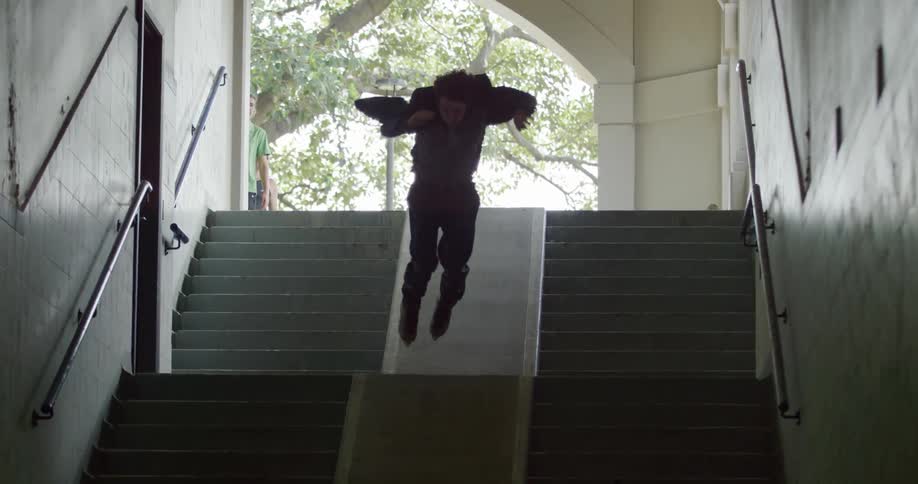 A man jumps the stairs on skates