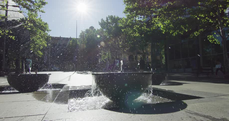 A rollerblader jumping over a fountain
