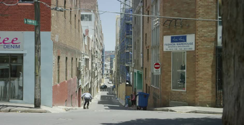 Man moves along the ground using roller skates in the street