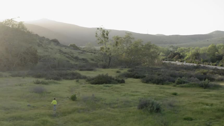 A child runs along a path