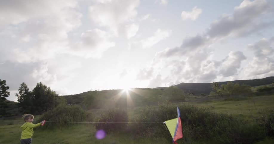 Child flies a kite in the air when the weather is windy
