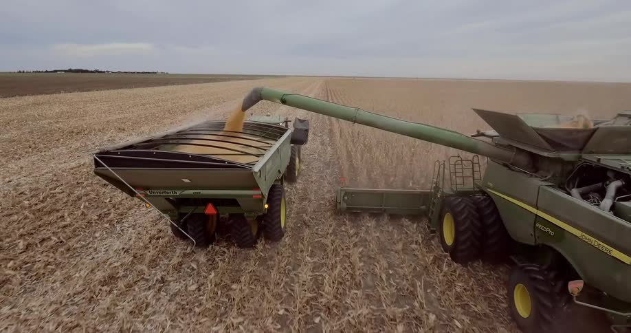 A tractor removes crops on a farm