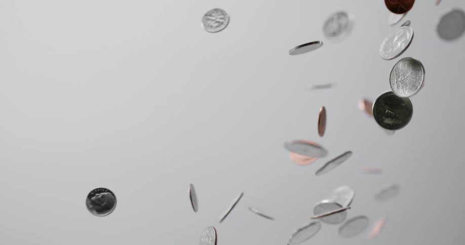 Coins being tossed up in the air and falling down