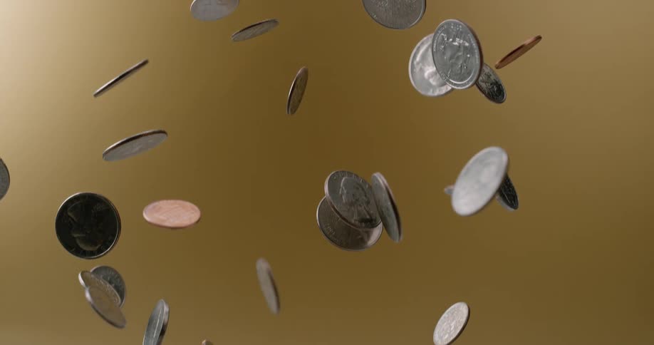 Coins of various denominations are tossed up into the air then fall back down