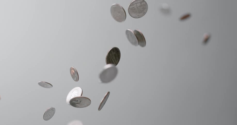 Coins drop in the white background