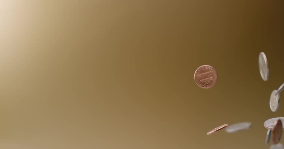 Coins tossed up into the air rise flip and fall back down