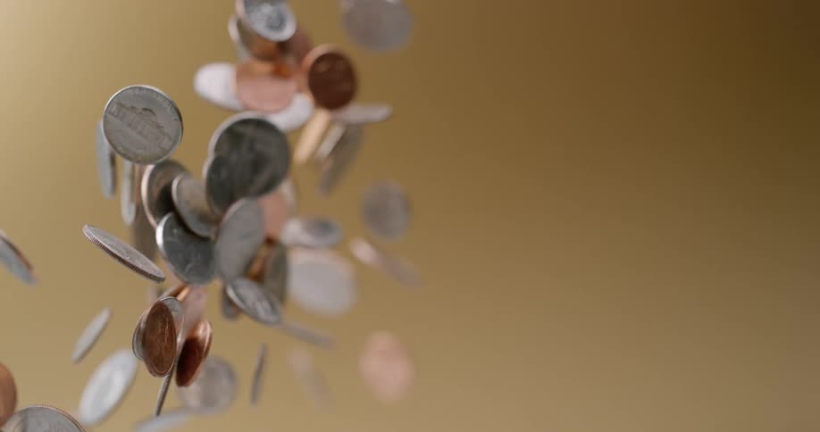 Loose change flying up in the air flipping and falling back down