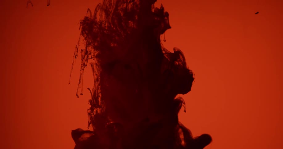 Black liquid water falls down in the red background