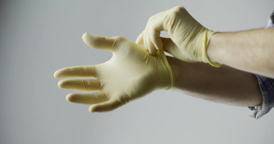 Male hands displaying proper way of wearing rubber gloves