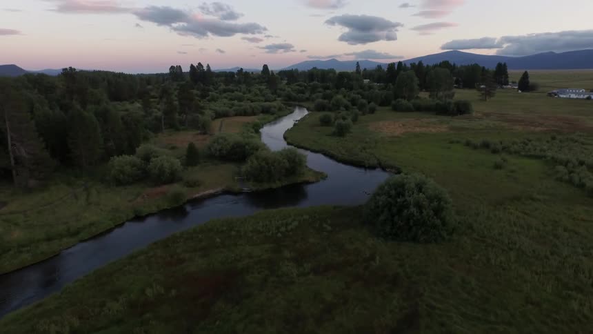 A river winding through a lightly forested plain