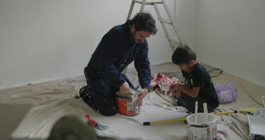A man opens the paint can