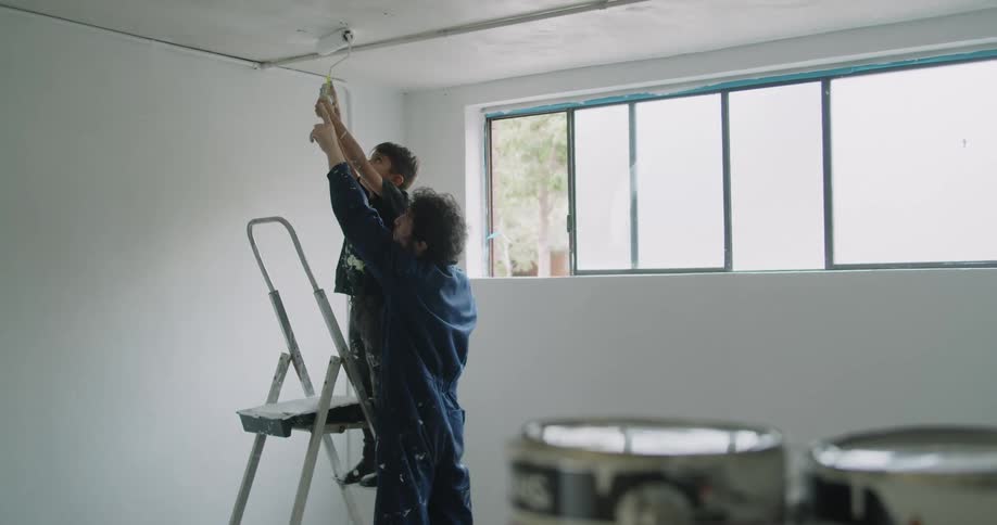 A father and son painting a room