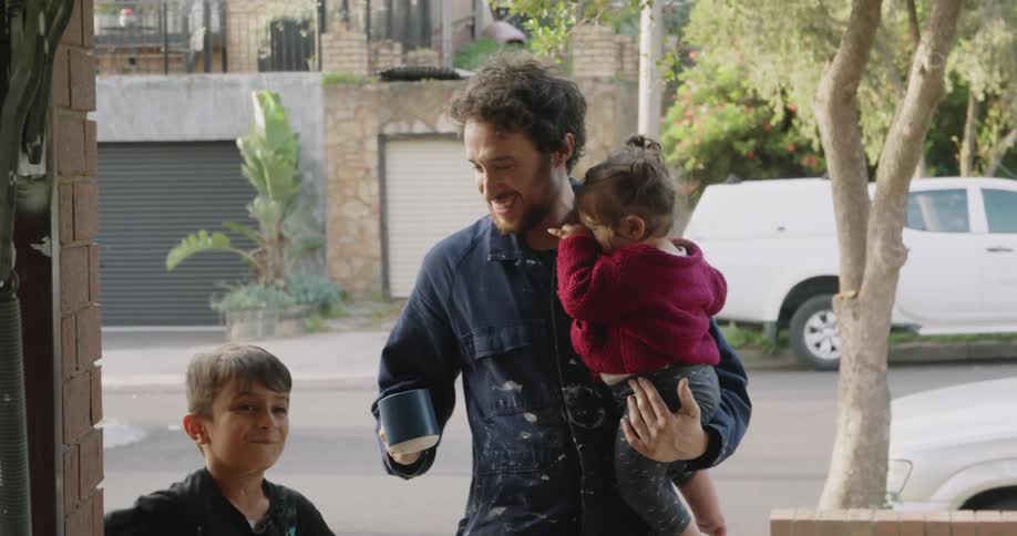 A father taking his two children outside