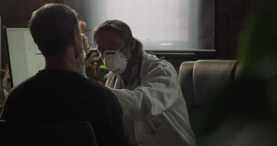 A doctor checks a patients face