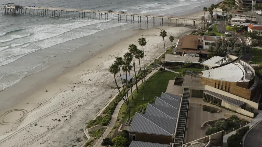 Buildings line the coast next to a beach