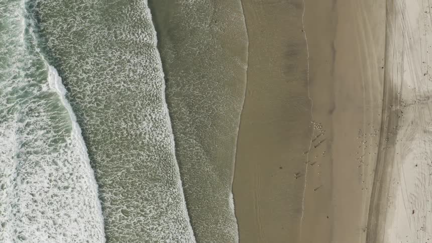 The waves splash onto the shoreline