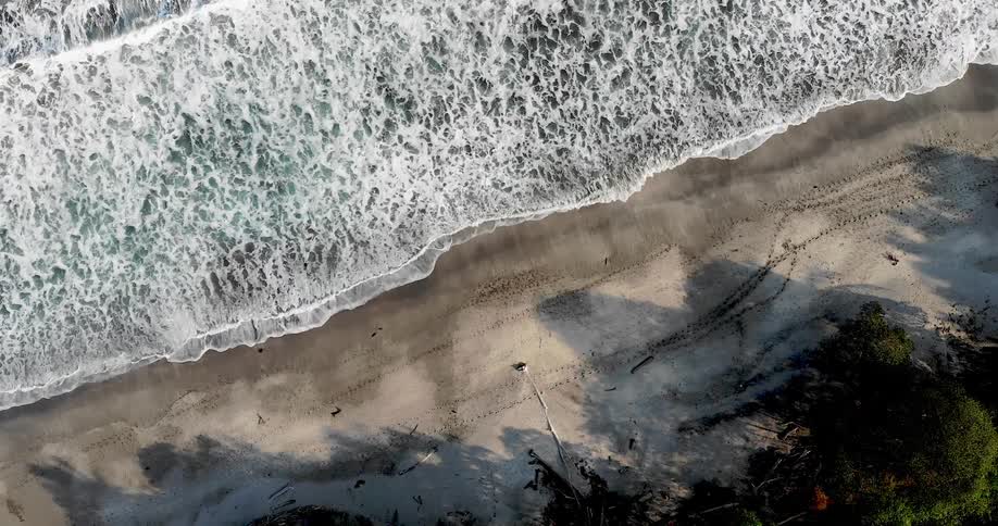 Waves roll in on a sandy beach