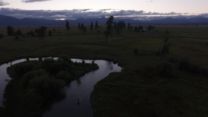 A small river flows through a grassy area