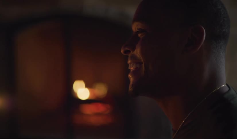 A black man talks and laughs