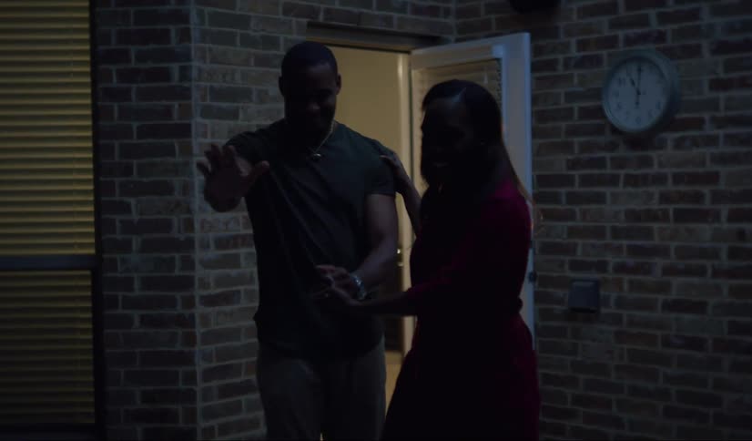A black woman leads man who has his eyes shut outdoors and he laughs at the surprise.
