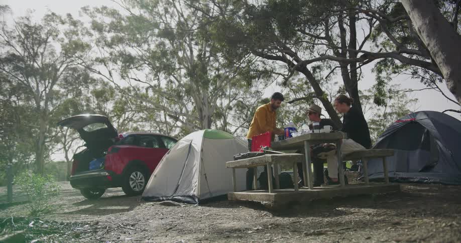 People are having food as they camp