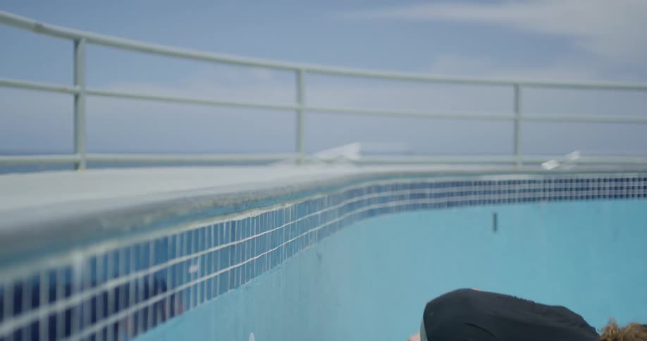 A person rollerblading into an empty pool