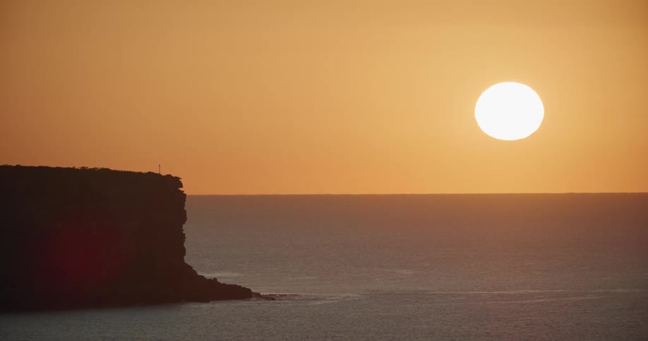 Sun sets over the ocean