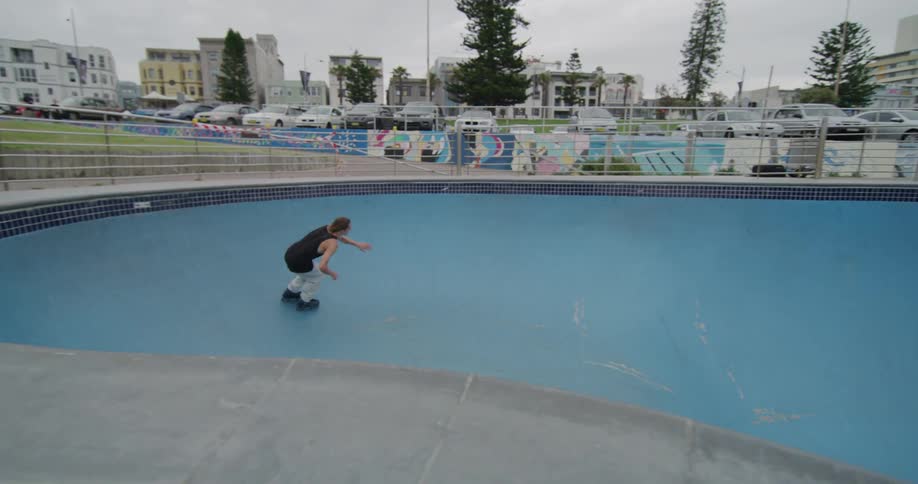 The man skates around the pool