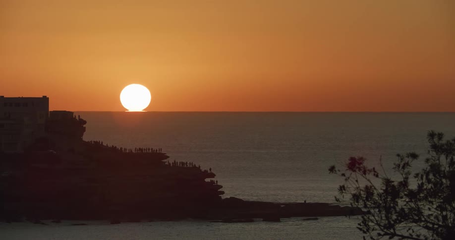 The sun rises over the ocean