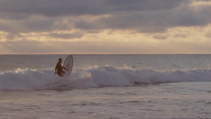 A surfer crashes on an ocean wave