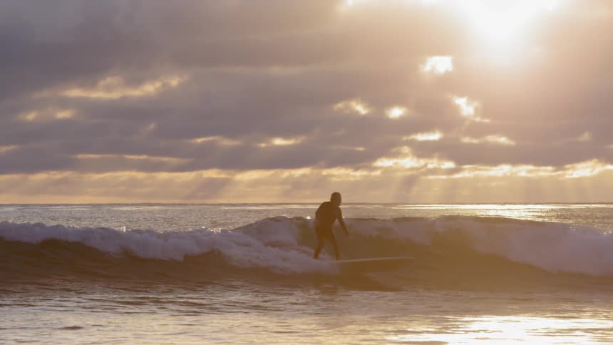 A surfer rides an ocean wave