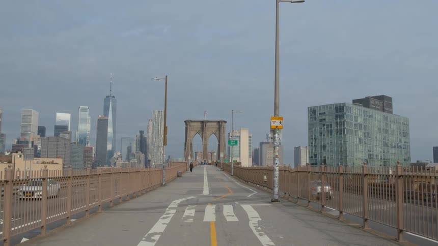 The biker and jogger run down Brooklyn Bridge