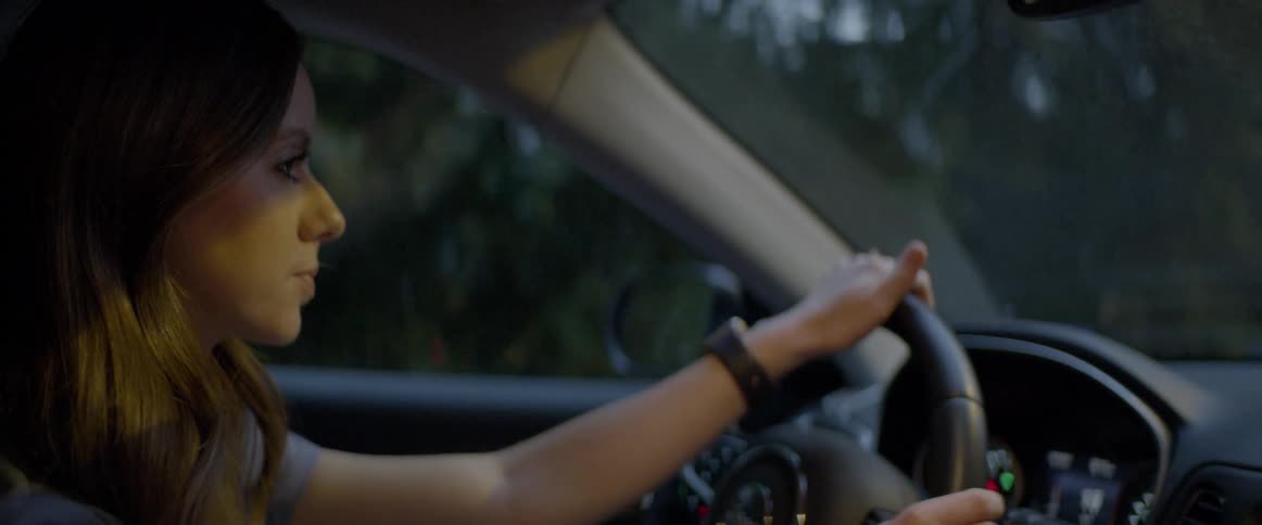 A woman is driving a car