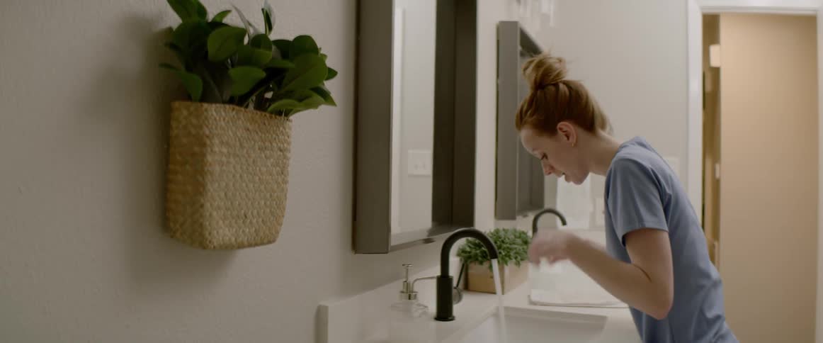 Woman freshens up in the bathroom