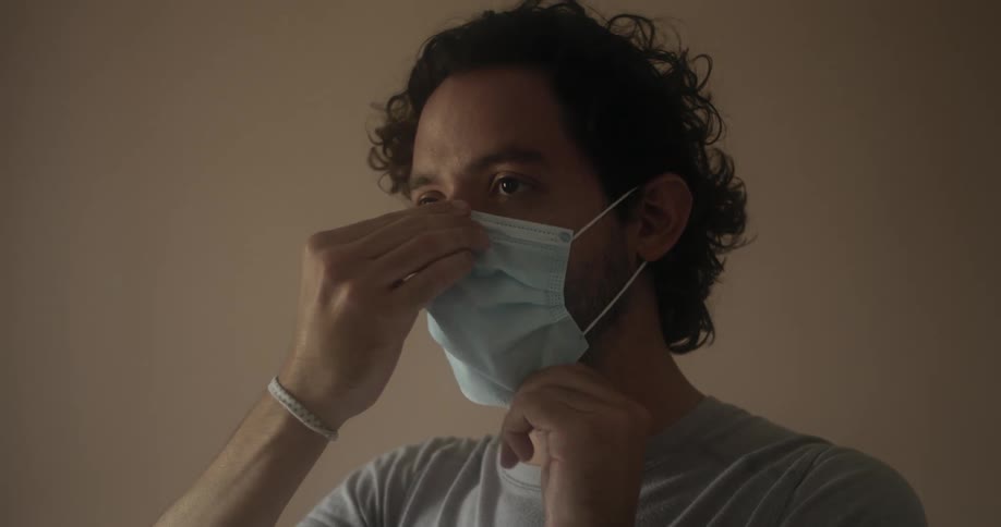Man demonstrates how to wear a face mask